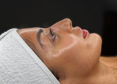 Close-up of a serene face with radiant skin at BY ALH, Essex, England, GB during a wellness treatment.