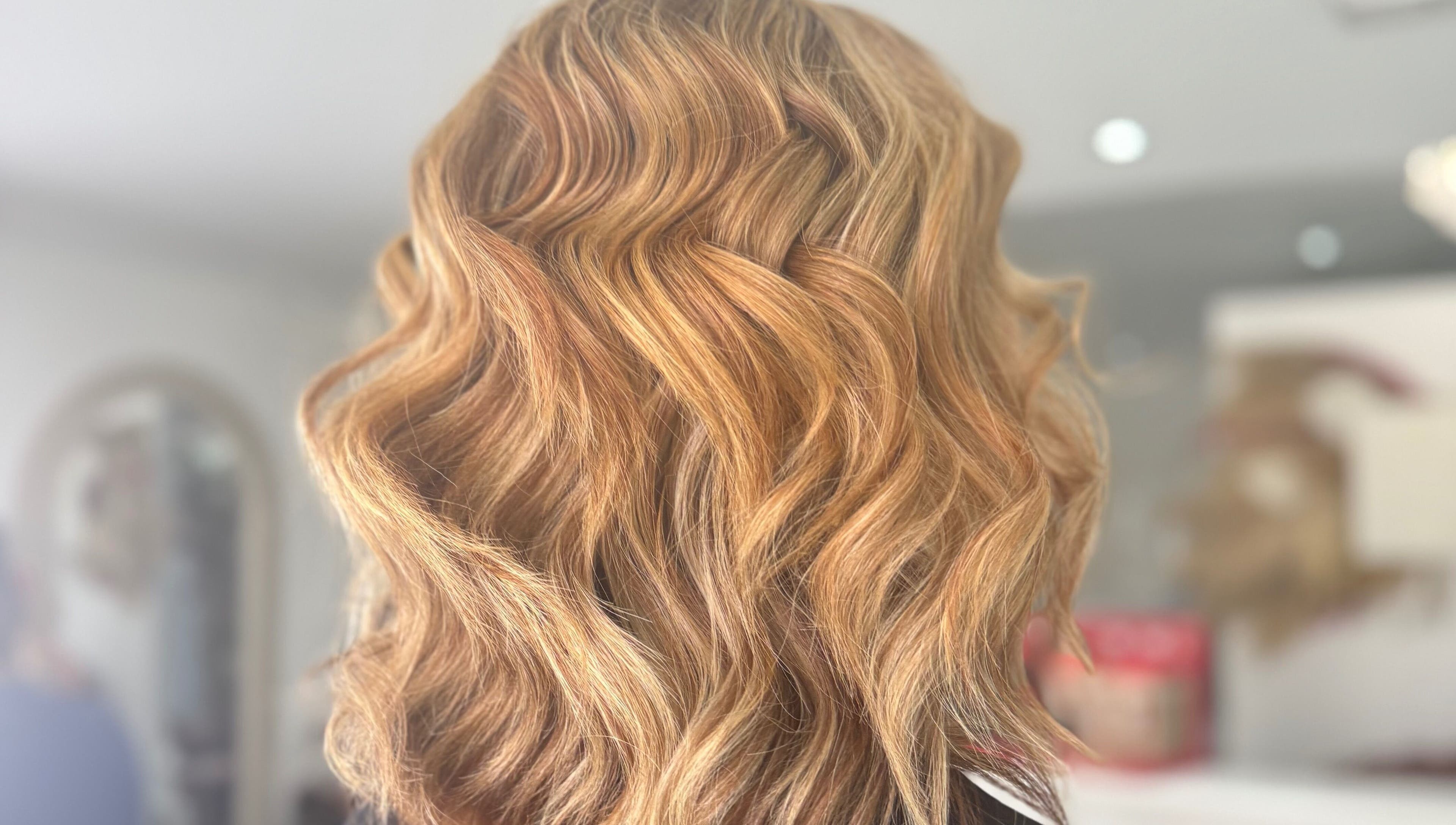 Golden wavy hairstyle showcased at DKB hairdressing, St Helens, England, GB salon.