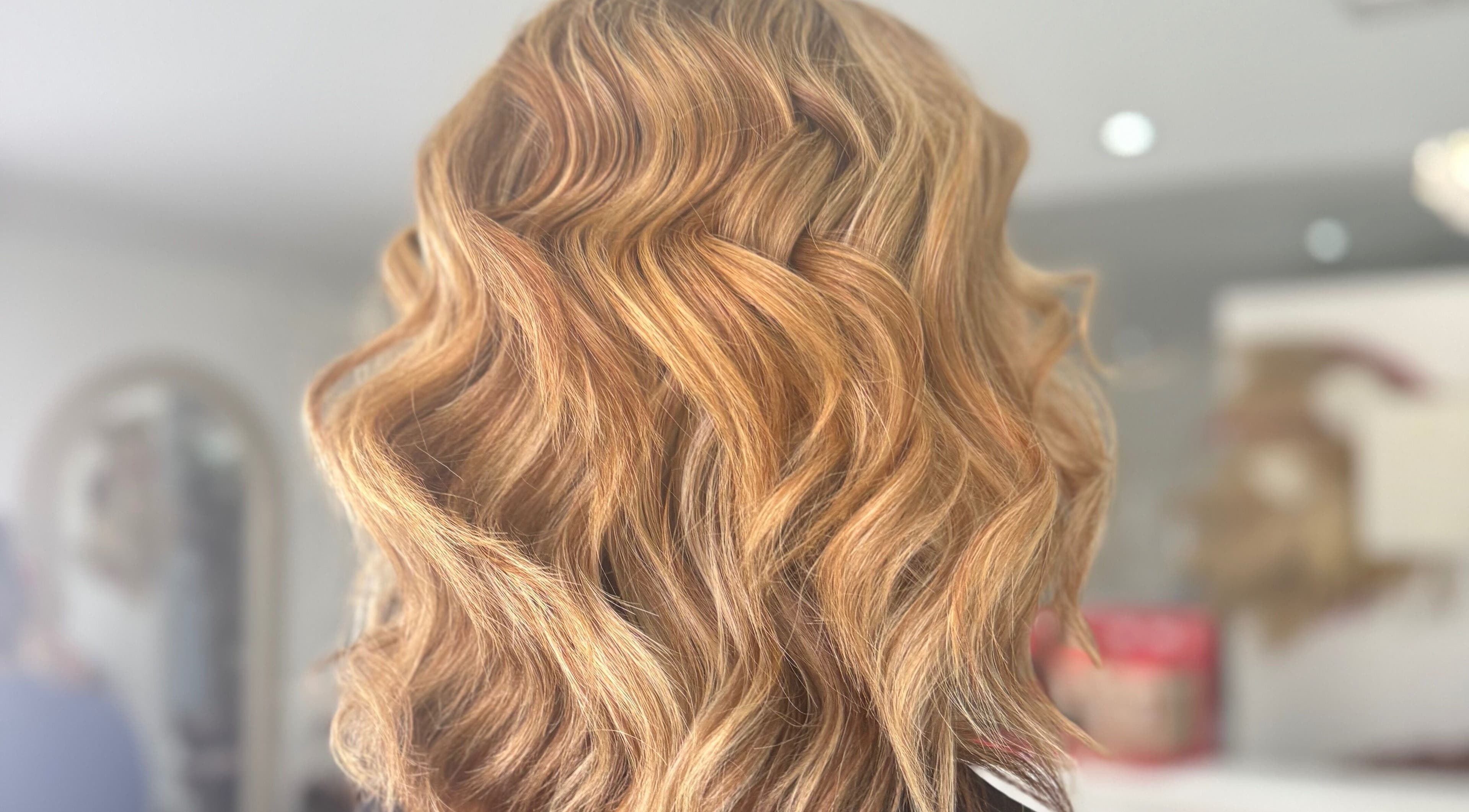 Golden wavy hairstyle showcased at DKB hairdressing, St Helens, England, GB salon.