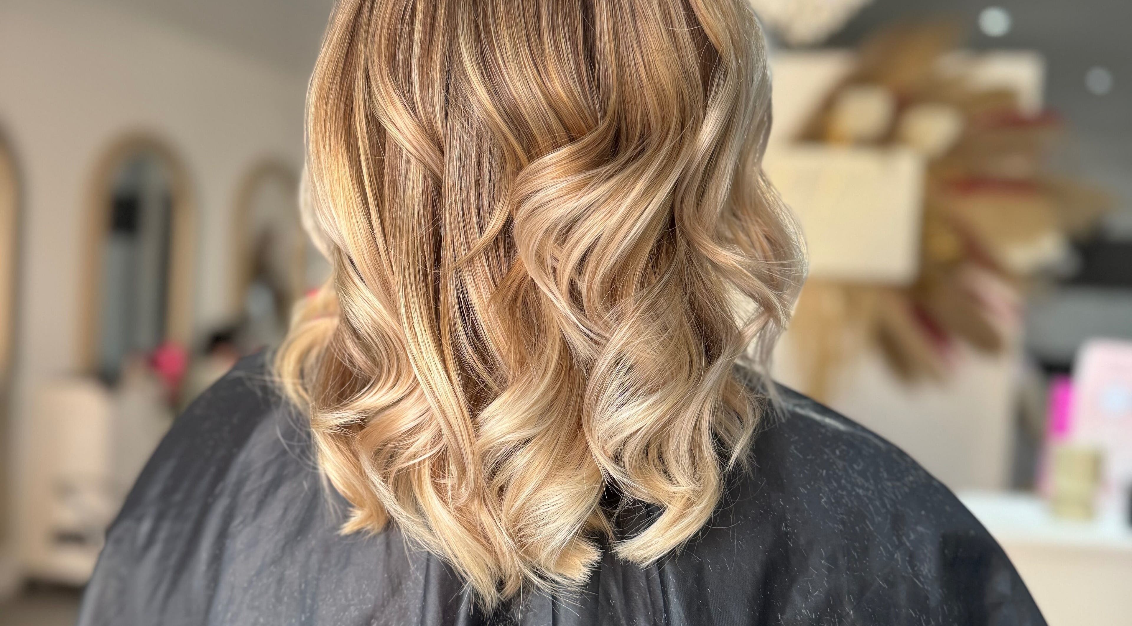 Blonde hair with soft waves styled at DKB hairdressing, St Helens, England, GB.