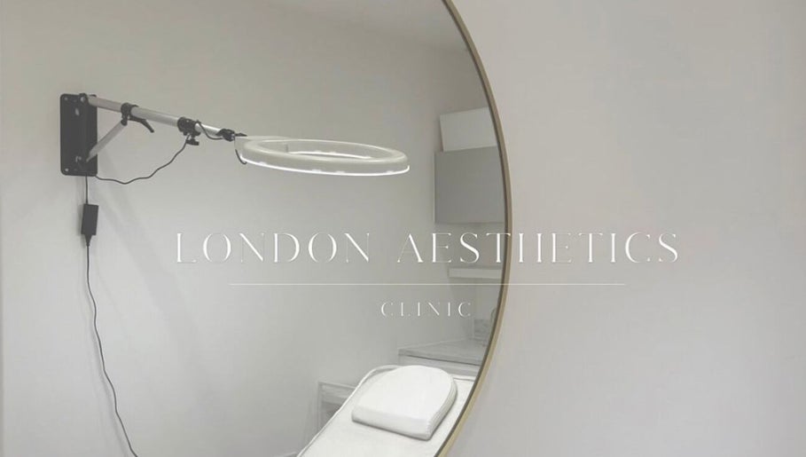 Elegant treatment room at London Aesthetic Clinic, London, England, GB, featuring a large round mirror.