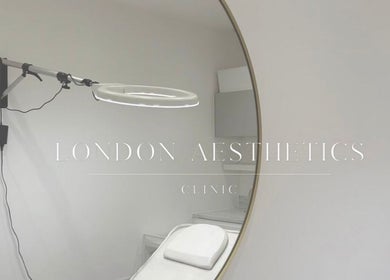 Elegant treatment room at London Aesthetic Clinic, London, England, GB, featuring a large round mirror.