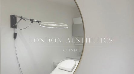 Elegant treatment room at London Aesthetic Clinic, London, England, GB, featuring a large round mirror.