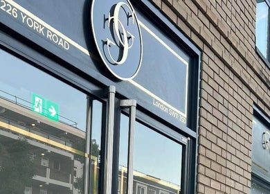 Entrance of London Aesthetic Clinic in London, England, GB, featuring sleek signage and glass doors.