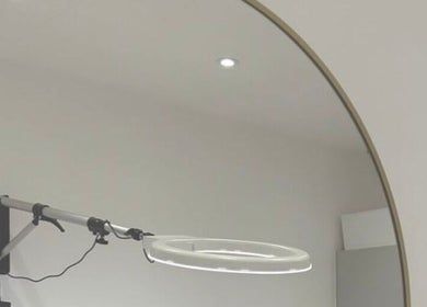 Modern ring lamp beside a sleek mirror at London Aesthetic Clinic - Battersea in London, England, GB.