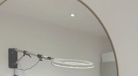 Modern ring lamp beside a sleek mirror at London Aesthetic Clinic - Battersea in London, England, GB.