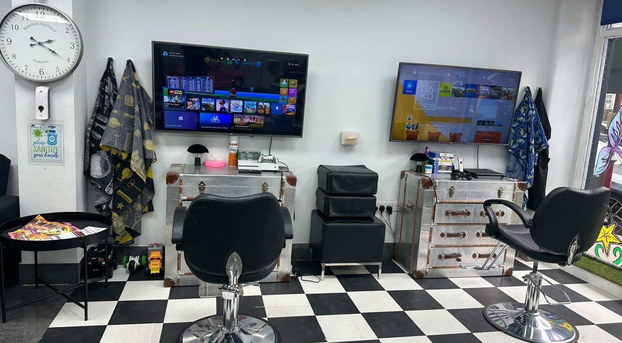 Modern gaming lounge area at Ocean Kids and Family Salon®, Radlett, England, GB, with stylish decor and chairs.