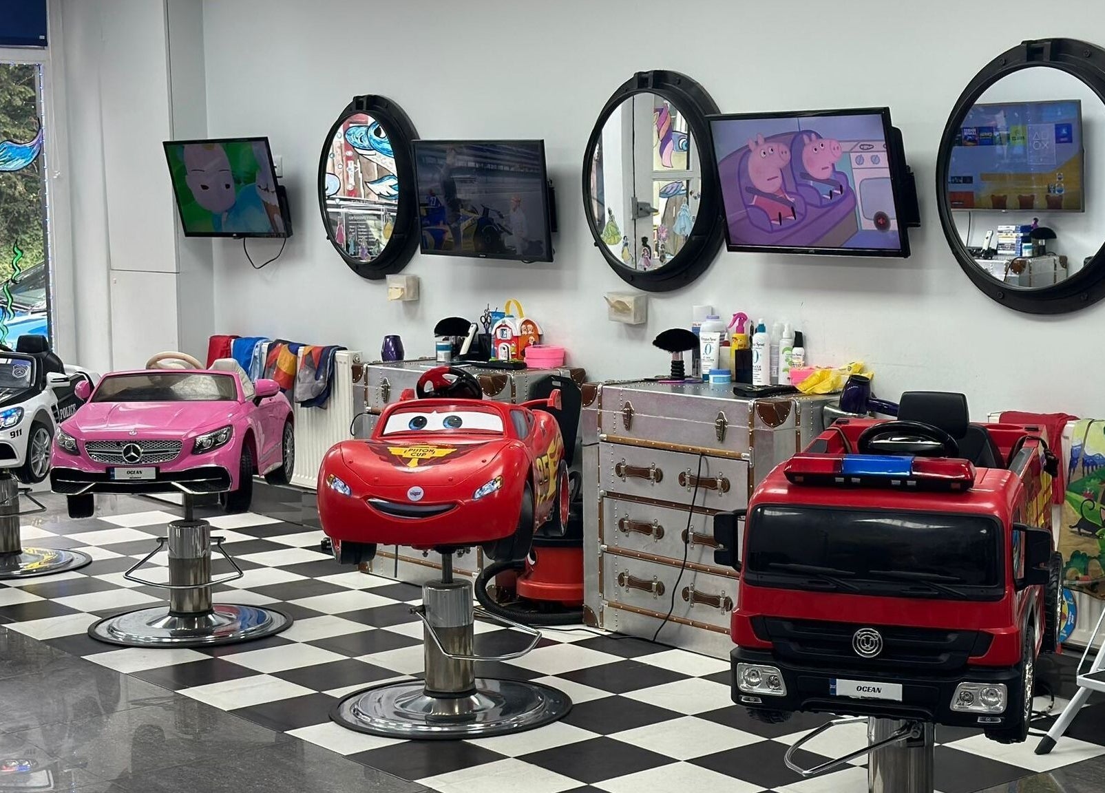 Bright car-themed salon chairs for kids at Ocean Kids and Family Salon, Radlett, England, GB.