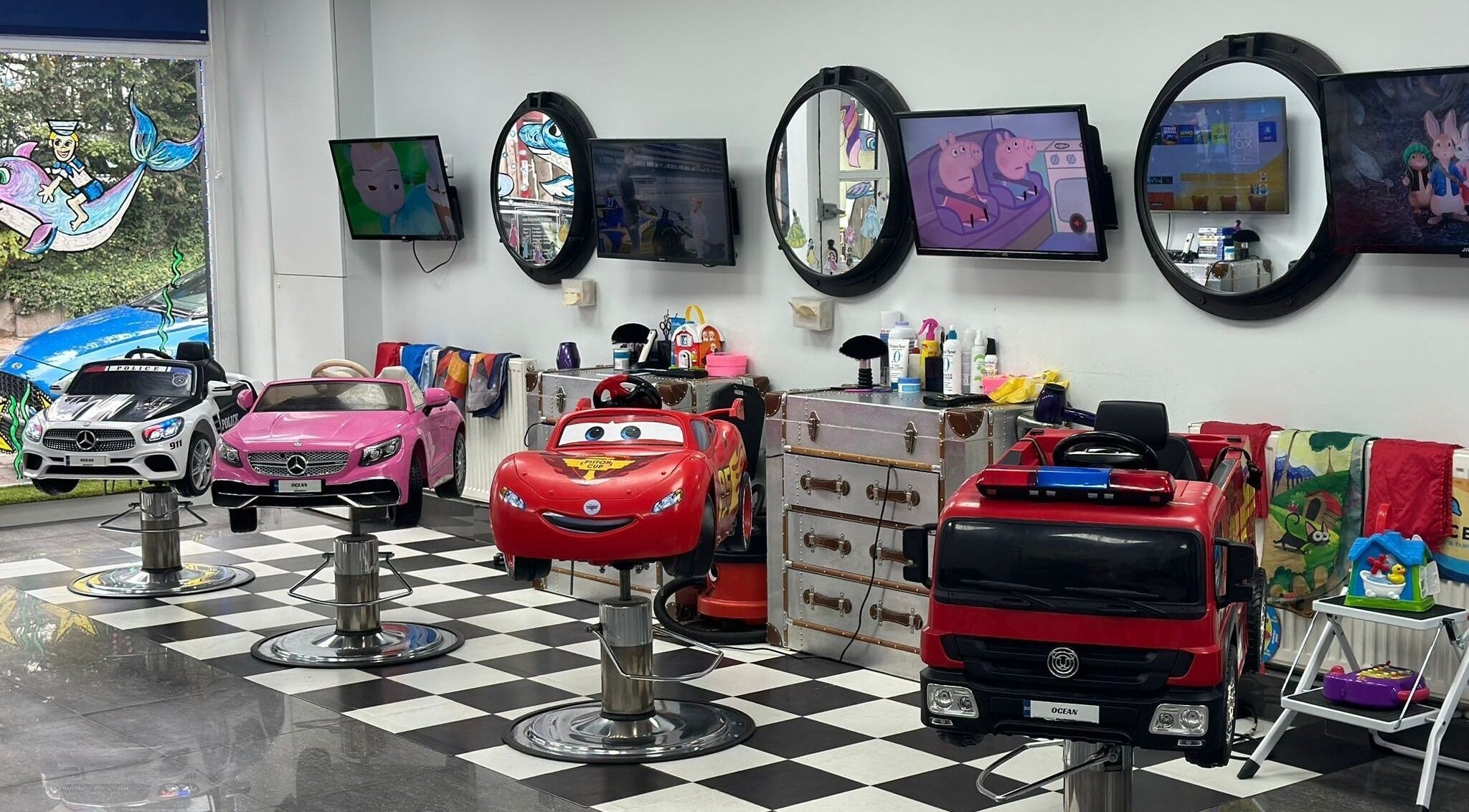 Bright car-themed salon chairs for kids at Ocean Kids and Family Salon, Radlett, England, GB.