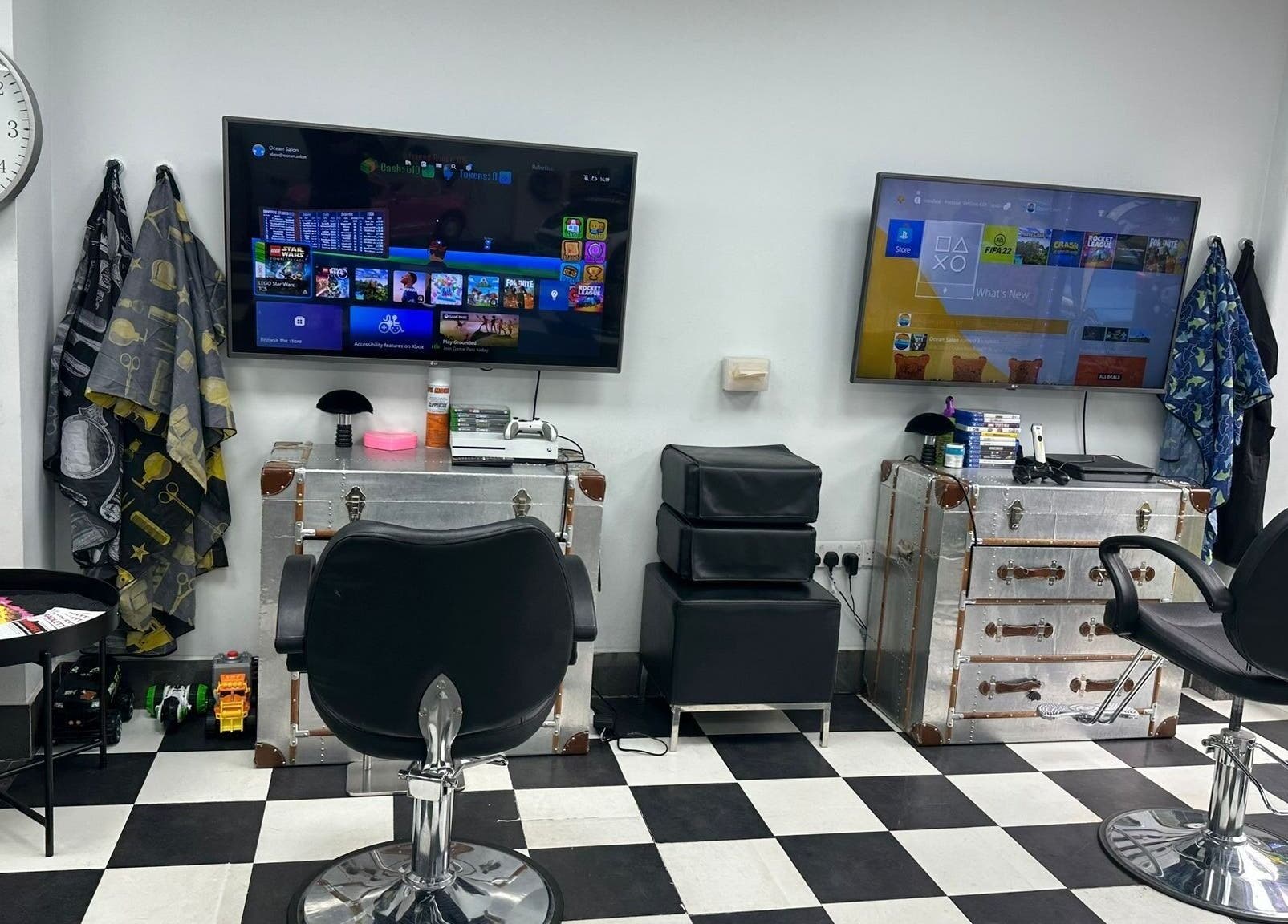 Modern gaming area in Ocean Kids and Family Salon, Radlett, England, GB. Stylish chairs and screens for entertainment.