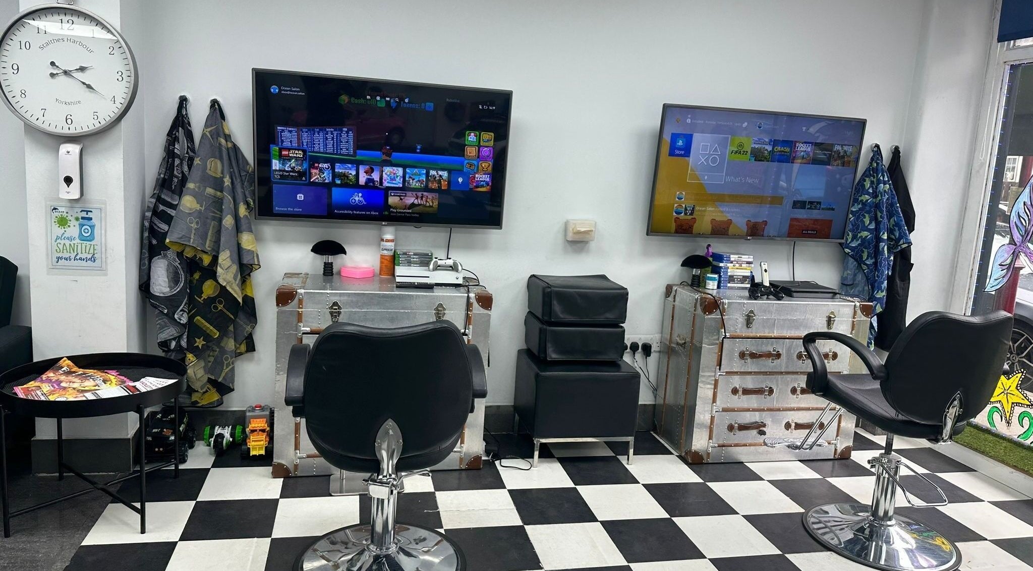 Modern gaming area in Ocean Kids and Family Salon, Radlett, England, GB. Stylish chairs and screens for entertainment.