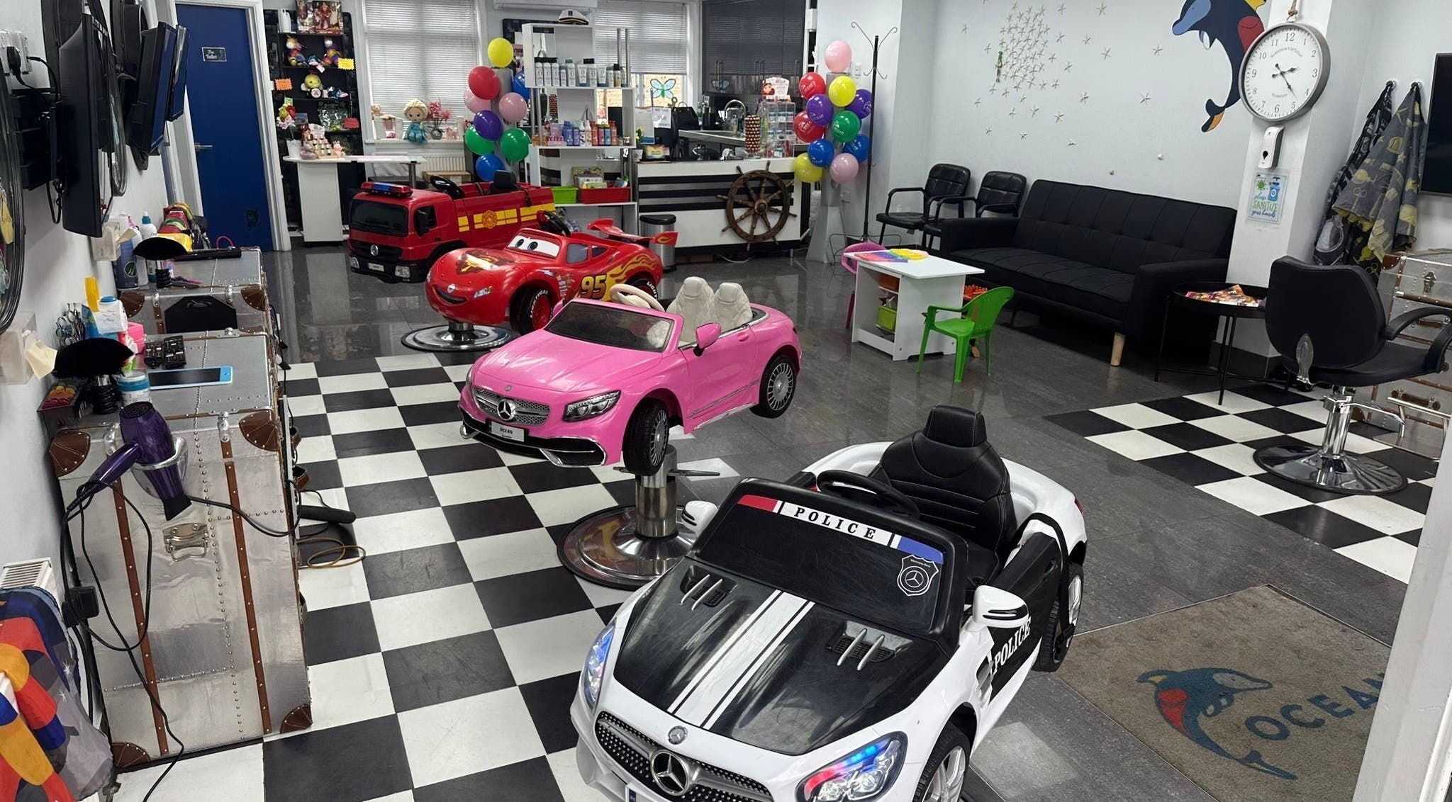 Ocean Kids and Family Salon in Radlett, England, GB with colorful car chairs for children.