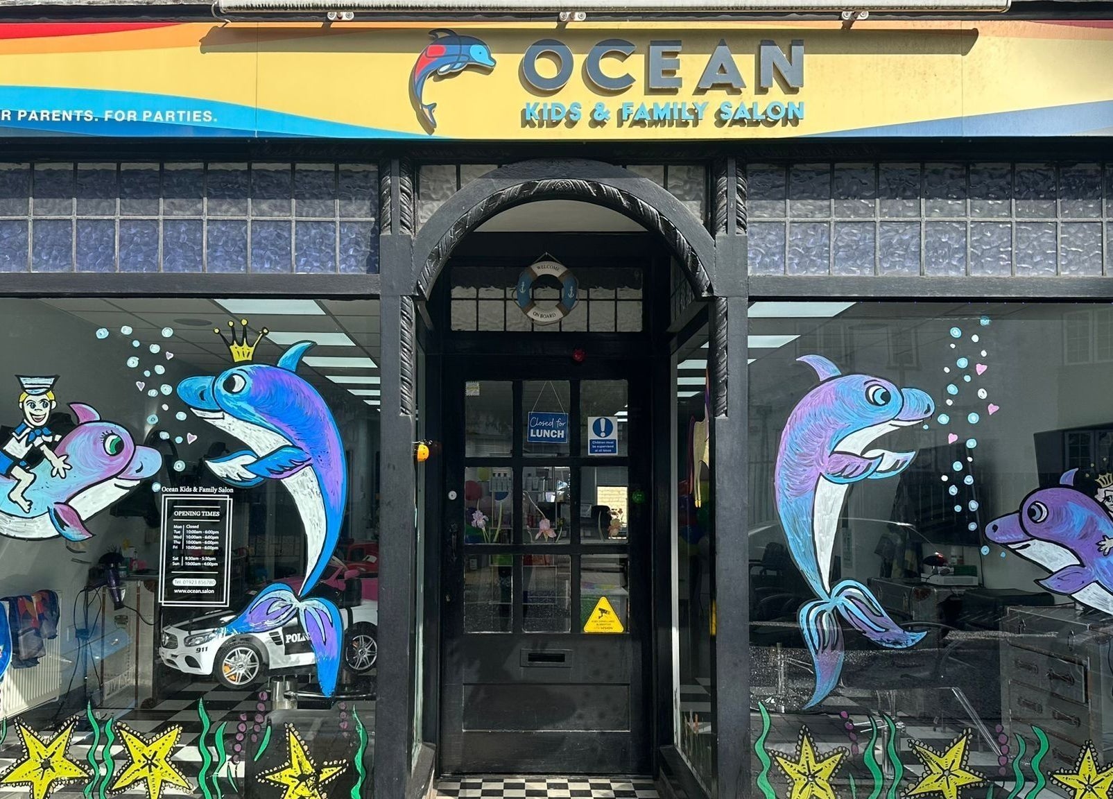 Vibrant exterior of Ocean Kids and Family Salon in Radlett, England, GB featuring colorful sea-themed artwork.