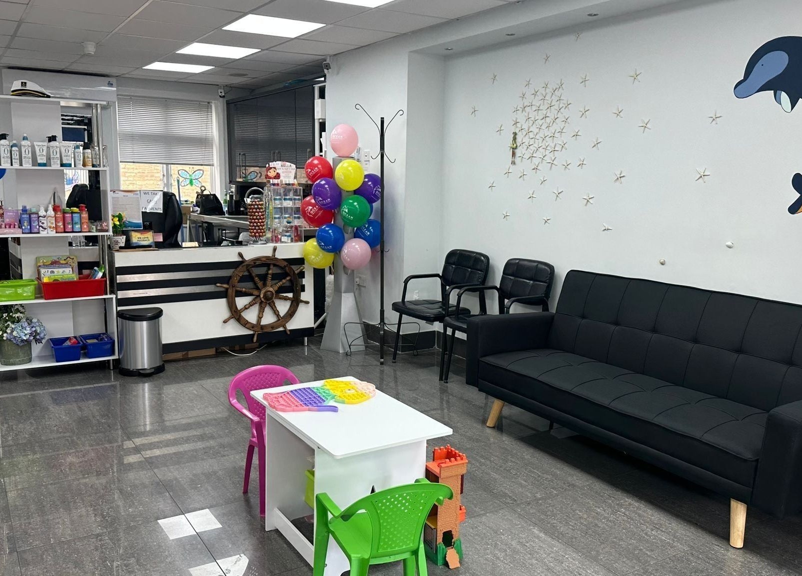 Spacious, kid-friendly interior of Ocean Kids and Family Salon in Radlett, England, GB with colorful decor.