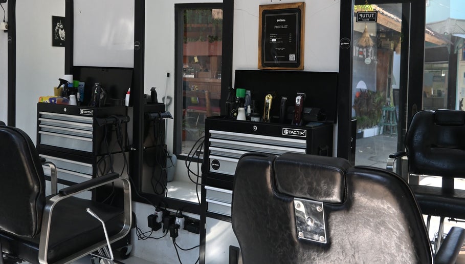 Interior of Gili Mates Barbershop showcasing chic barber chairs and grooming tools in Nusa Tenggara Barat, ID.