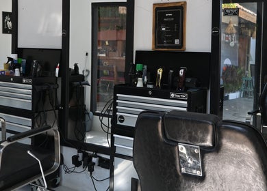Interior of Gili Mates Barbershop showcasing chic barber chairs and grooming tools in Nusa Tenggara Barat, ID.
