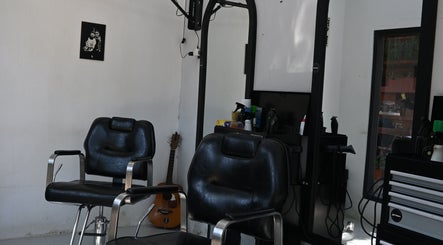 Modern barber chairs at Gili Mates Barbershop in Nusa Tenggara Barat, ID create an inviting atmosphere.