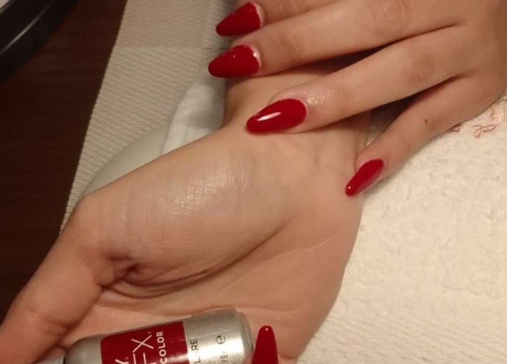 Red manicure at Masdool Salon, Dammam, Eastern Province, SA, showcasing vibrant nail beauty.