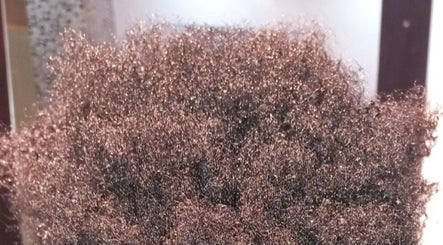 Close-up of natural textured curls at Miss J'z Hair and Beauty Bar, Cape Town, Western Cape, ZA.