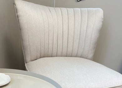 Elegant cream chair at The Skin Corner by Amy, Shaftesbury, England, GB, offering a serene ambiance.