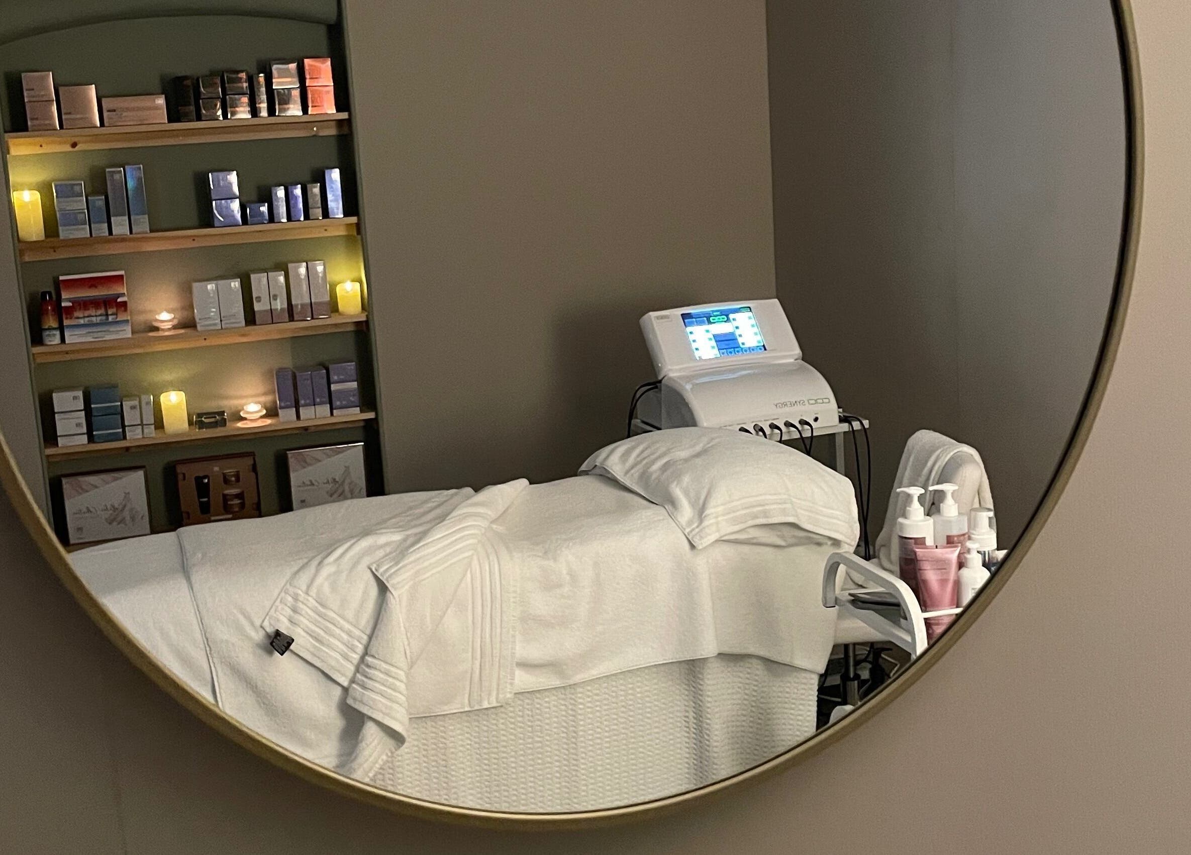 Cozy treatment room at The Skin Corner by Amy, Shaftesbury, England, GB, with spa bed and beauty products.