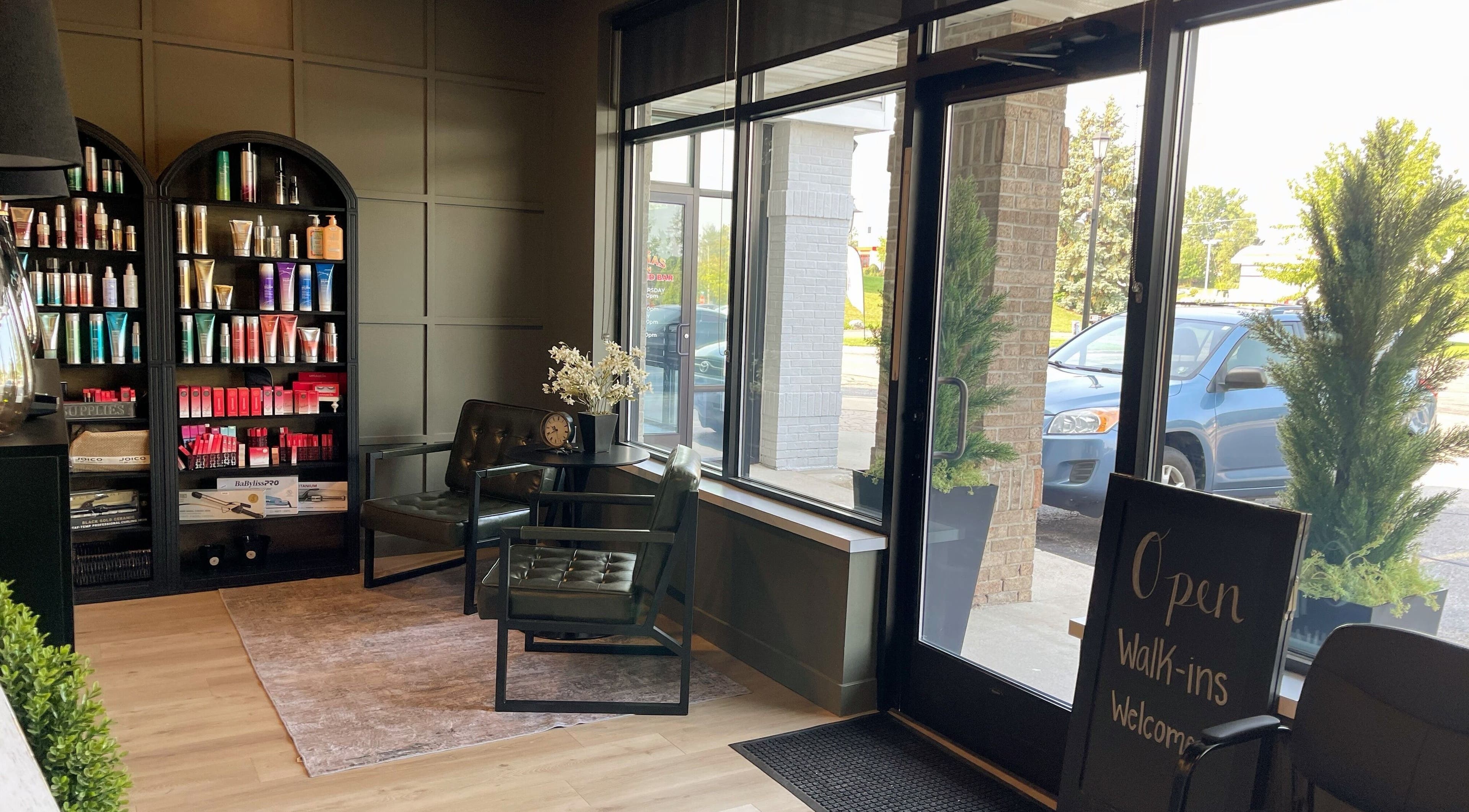 Elegant interior of Matt Flora Hair Studio in Hudsonville, Michigan, showcasing products and seating area.