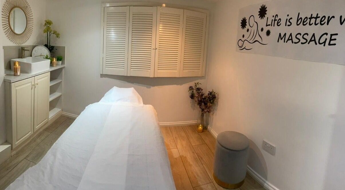 Peaceful massage room at U&I Thai Spa in London, England, GB, with a cozy bed and calming decor.