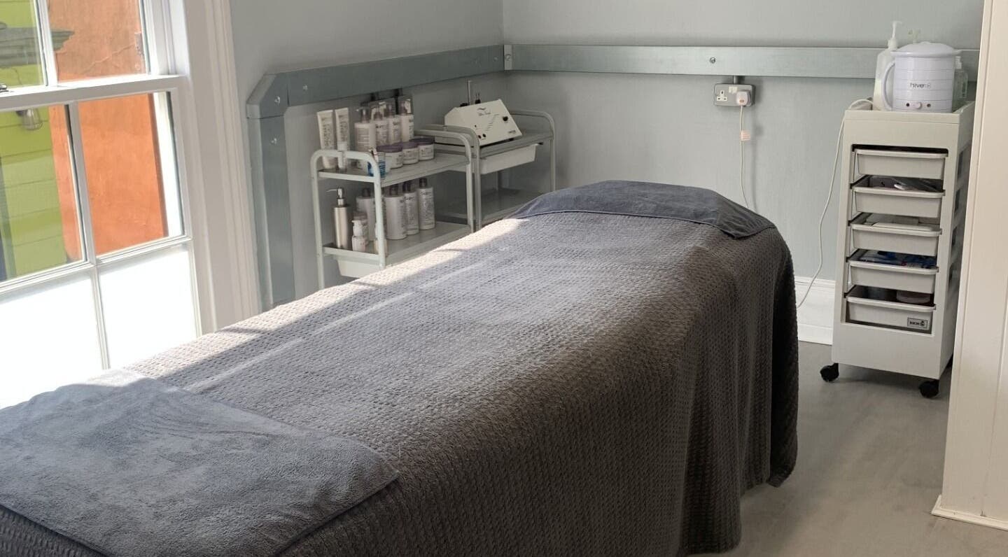 The Beauty Loft treatment room in Falmouth, England, GB offers a tranquil setting with a cozy massage bed.