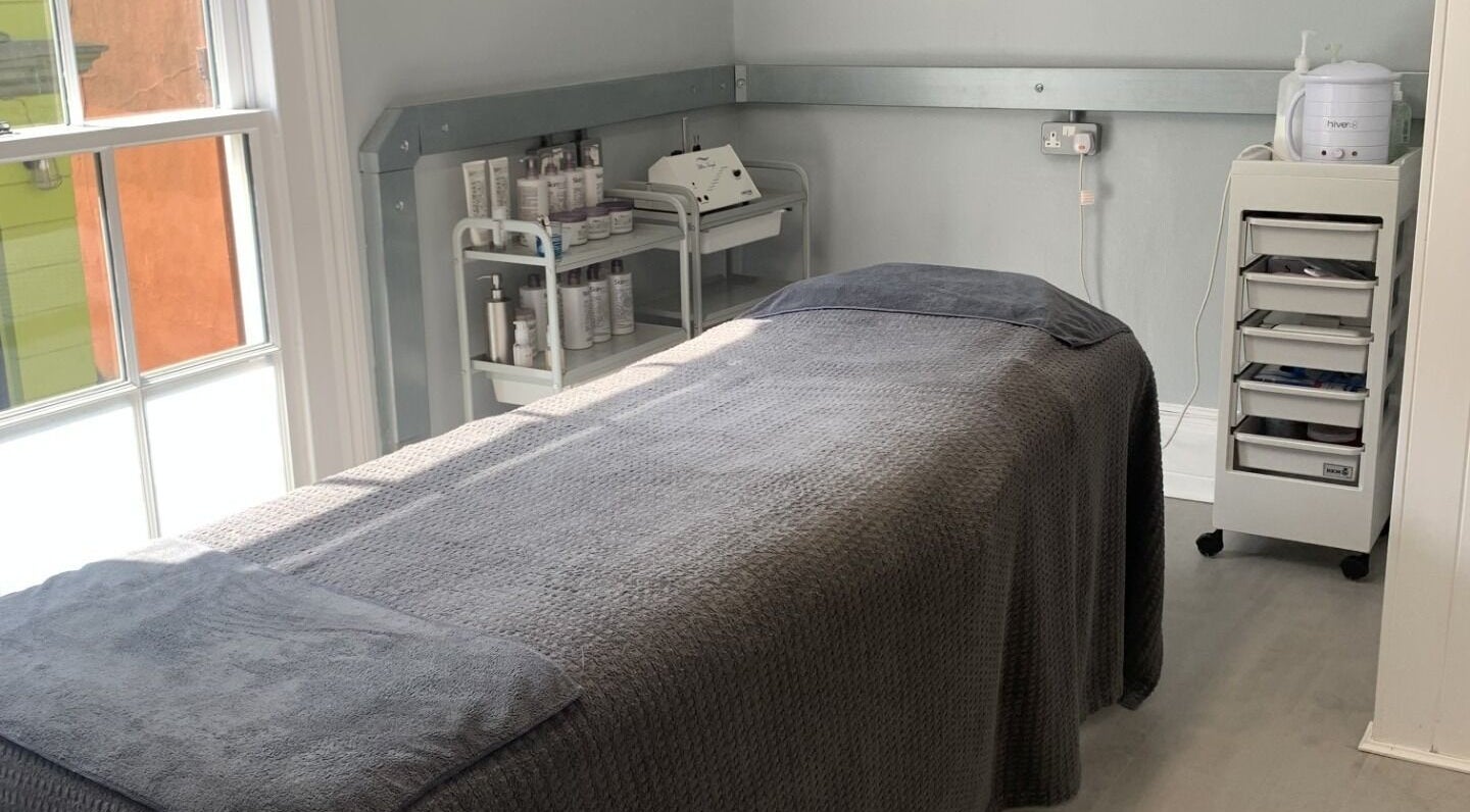 The Beauty Loft treatment room in Falmouth, England, GB offers a tranquil setting with a cozy massage bed.