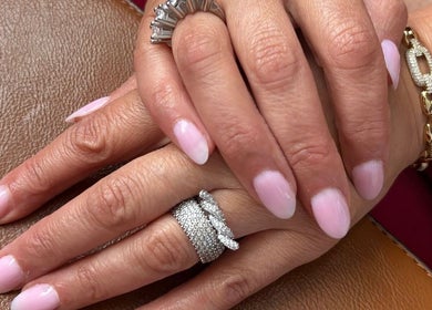Manicured hands with pink nails at Heavenly Aesthetics, Stoke-on-Trent, England, GB.
