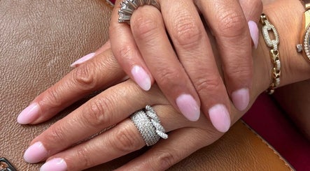 Manicured hands with pink nails at Heavenly Aesthetics, Stoke-on-Trent, England, GB.