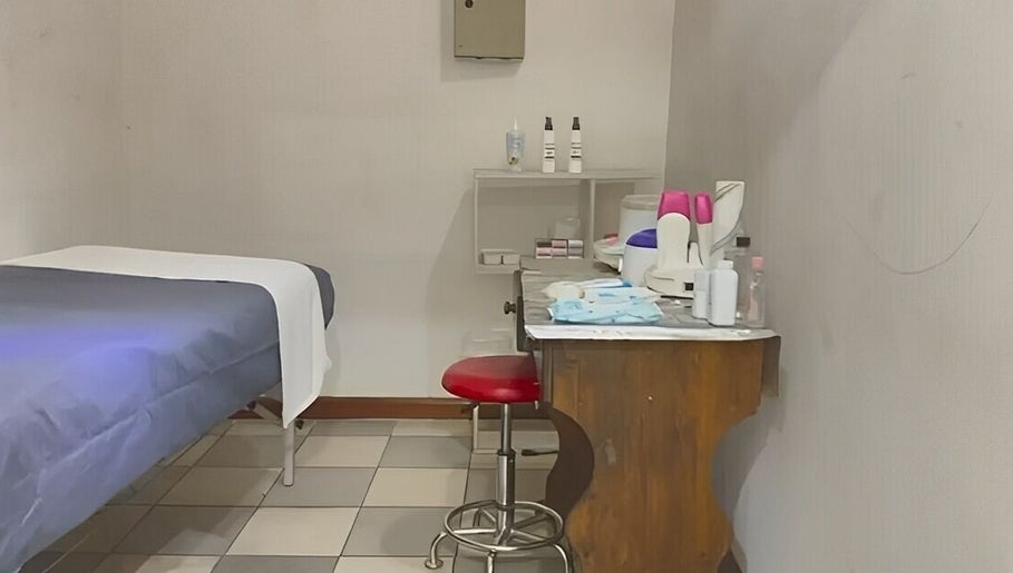 Serenity Glamour's cozy treatment room in Germiston, Gauteng, ZA, featuring a massage bed and beauty equipment.