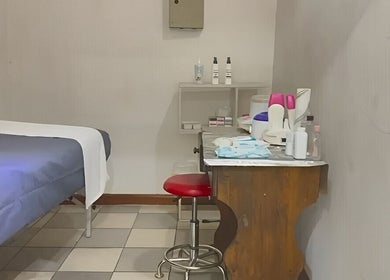 Serenity Glamour's cozy treatment room in Germiston, Gauteng, ZA, featuring a massage bed and beauty equipment.