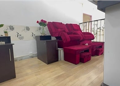 Cozy red chair corner at Serenity Glamour, Germiston, Gauteng, ZA, offering tranquil pampering ambiance.