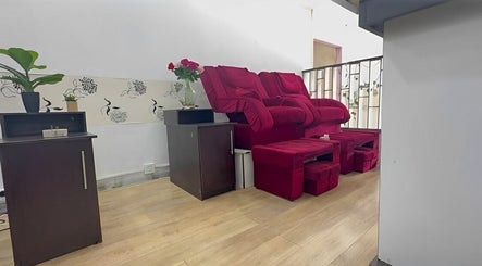 Cozy red chair corner at Serenity Glamour, Germiston, Gauteng, ZA, offering tranquil pampering ambiance.