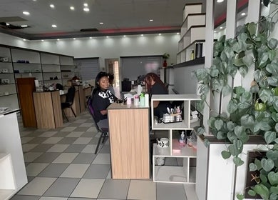 Modern salon interior at Serenity Glamour, Germiston, Gauteng, ZA, showcasing welcoming ambiance and stylish decor.