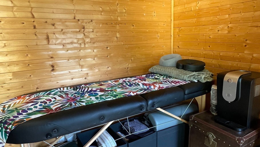 Cozy massage room at Green Cabin Beauty at Mill Meadows, Newport, England, GB with a wooden interior.