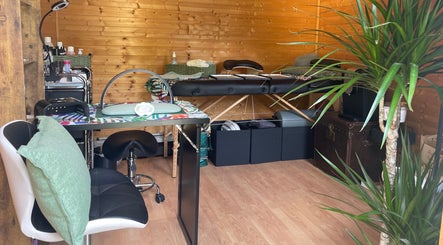 Tranquil beauty room at Green Cabin Beauty, Mill Meadows, Newport, England, GB, featuring lush greenery and modern decor.