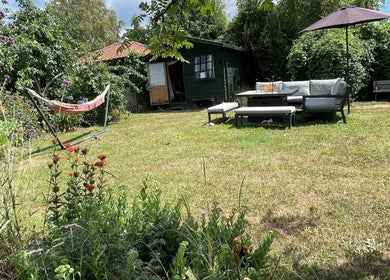 Serene garden at Green Cabin Beauty at Mill Meadows, Newport, England, GB with hammock and cozy seating.