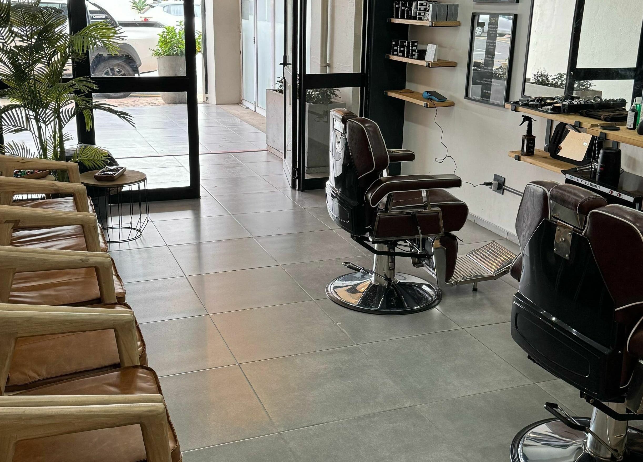 Relaxing interior of The Old Harbour Barber in Hermanus, Western Cape, ZA showcasing chairs and styling area.