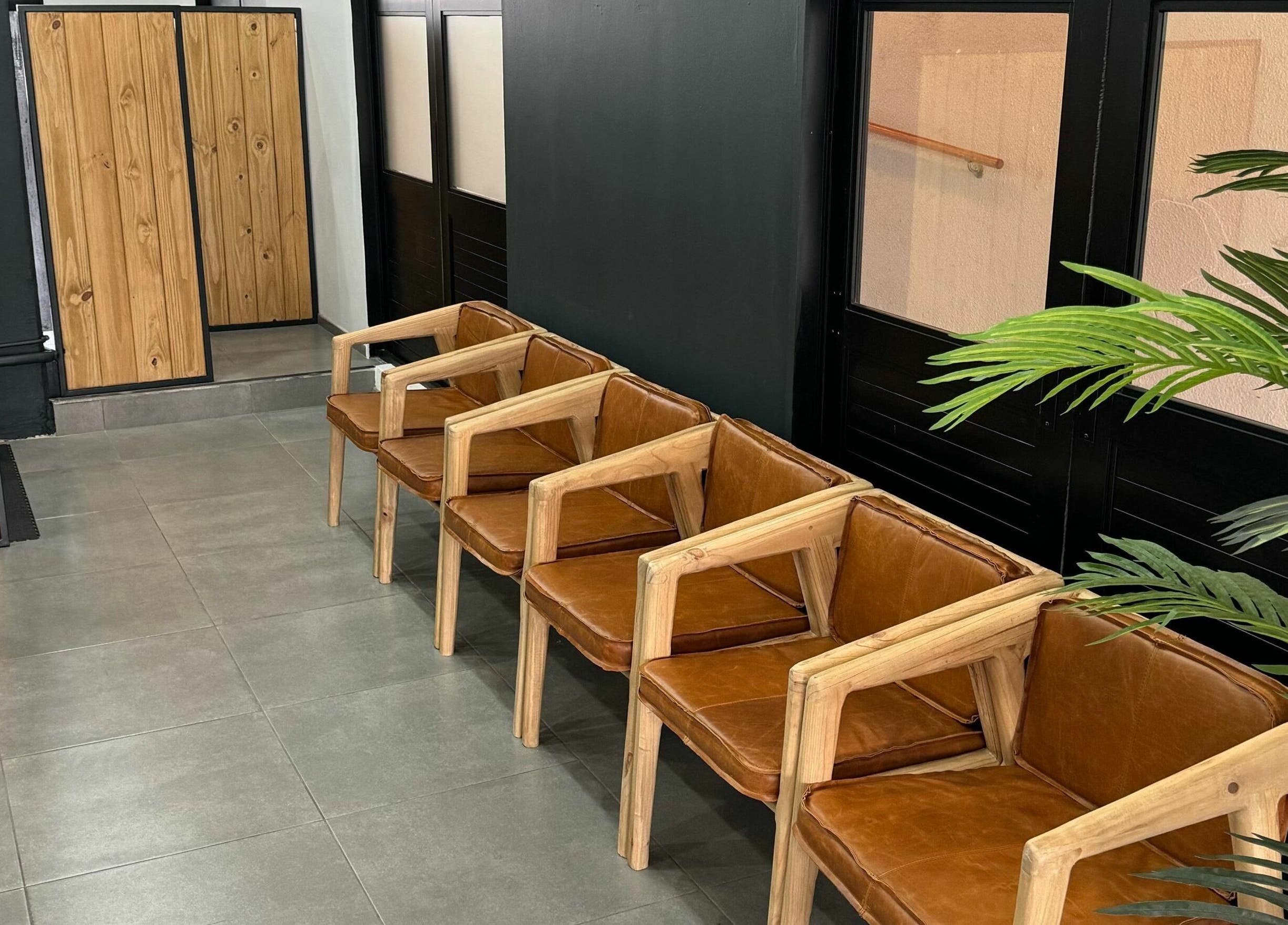 Modern leather seating in The Old Harbour Barber, Hermanus, Western Cape, ZA, highlighting comfort and style.