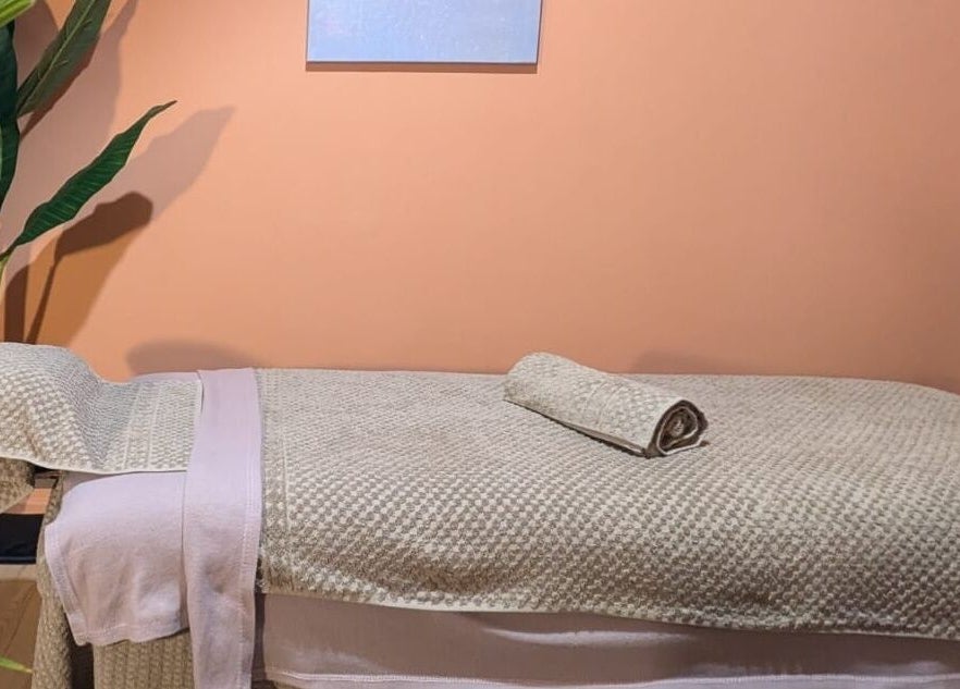 Cozy massage room at Remedy Room West, Glasgow, Scotland, GB with a massage table and soothing decor.