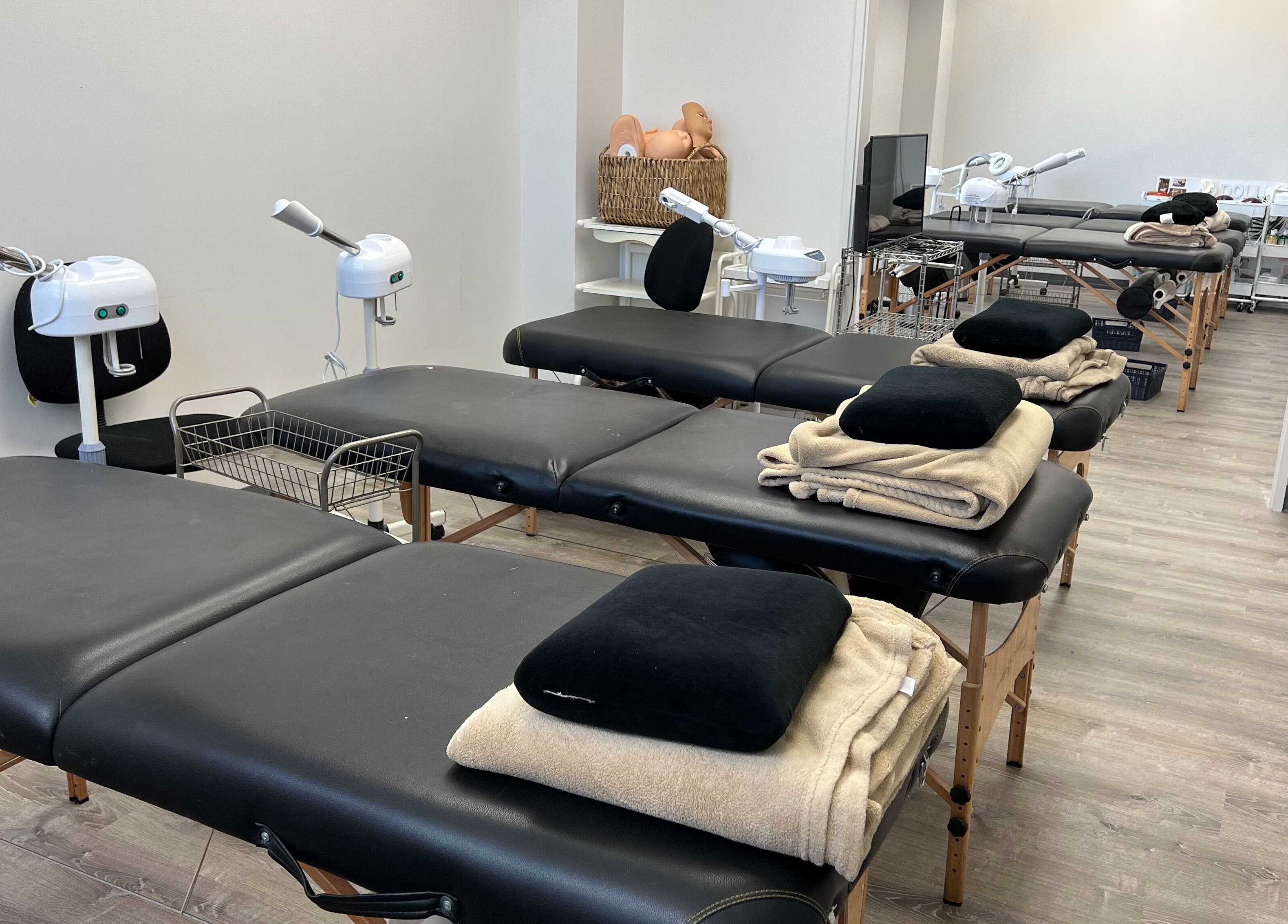 Spacious treatment room at HNA Est Hybrid Online Students in Honolulu, Hawaii, US with multiple massage tables.