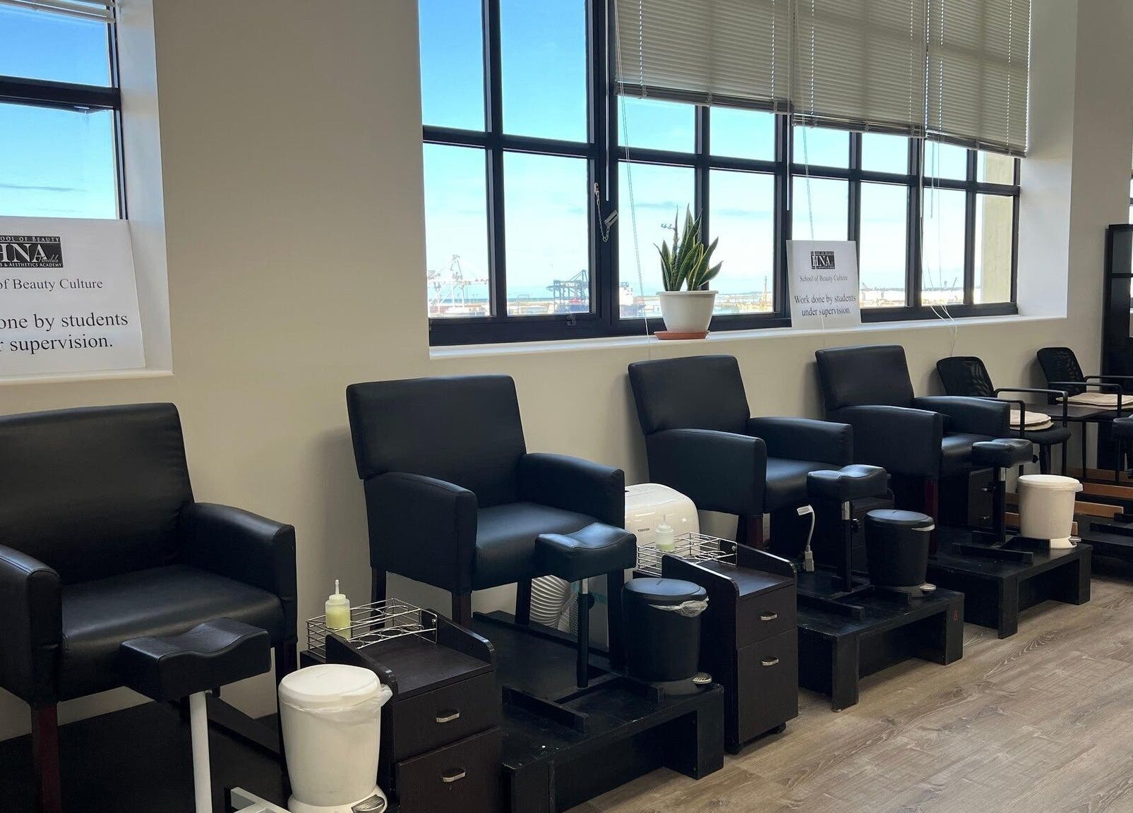 Modern salon chairs at HNA Est Hybrid Online Students in Honolulu, Hawaii, US. Bright space with coastal views.
