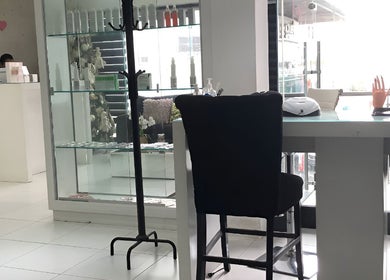 Área de recepción moderna en Miss Glam, Reynosa, Tamaulipas, MX. Destacan sillas elegantes y productos en exhibición.