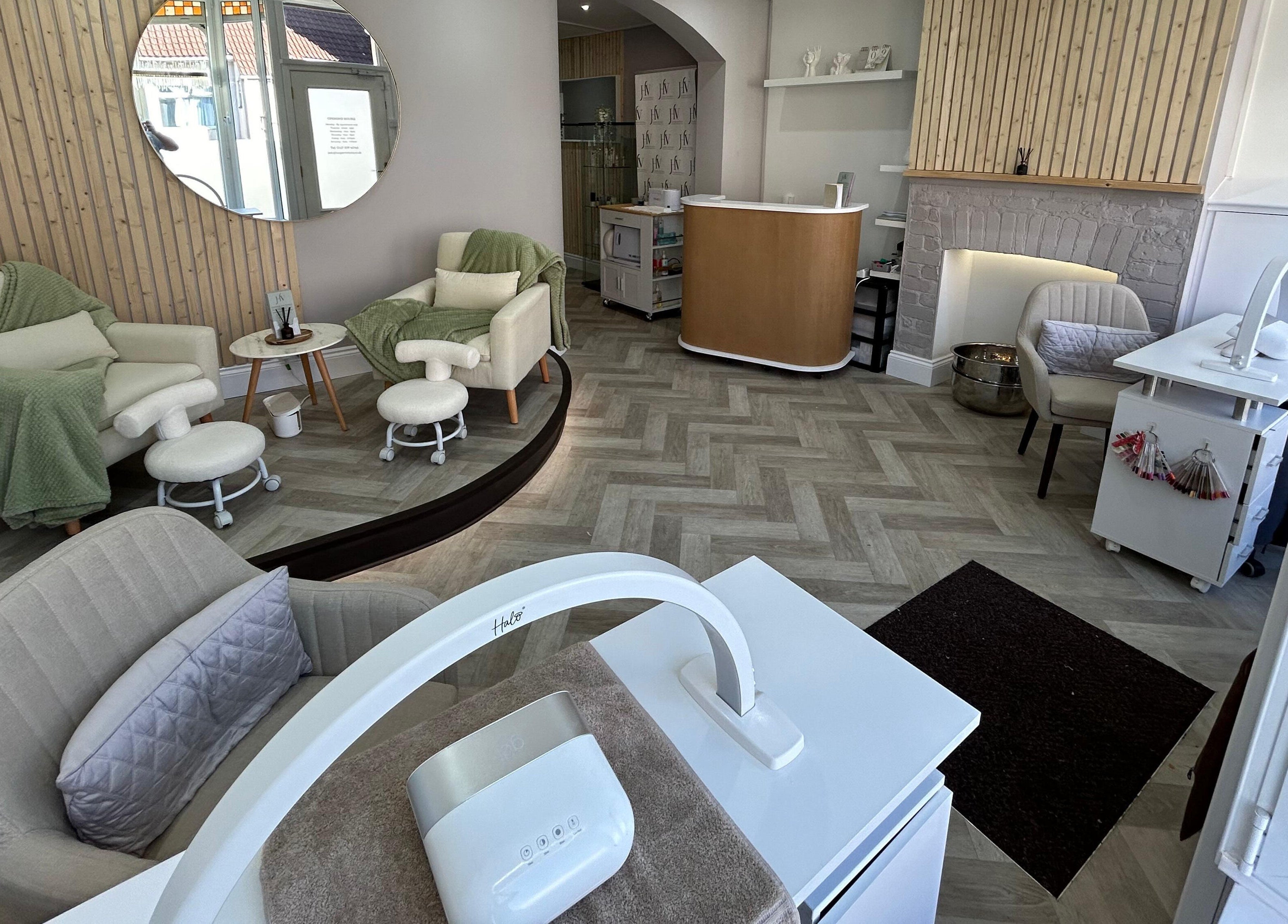 Relaxing treatment area at Harper Victoria Aesthetics in Bristol, England, GB, featuring plush chairs and soothing decor.