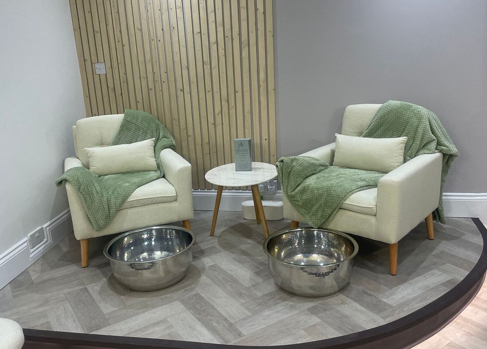 Cozy corner at Harper Victoria Aesthetics, Bristol, England, GB, featuring chairs and foot basins.