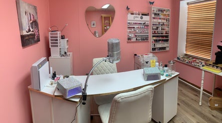 Cozy nail station at Marie’s Nail Loft in Bonner Springs, Kansas, US with pink decor and multiple polish options.