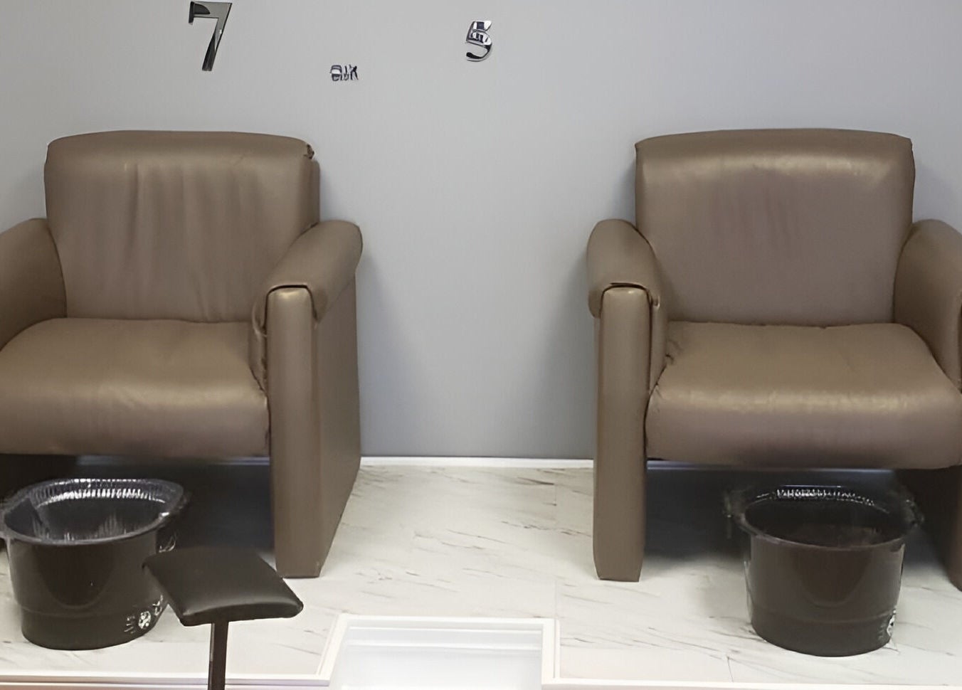 Relaxing pedicure chairs at Embellished Beauty - Dundalk 52 Main St E, Dundalk, Ontario, CA on marble flooring.