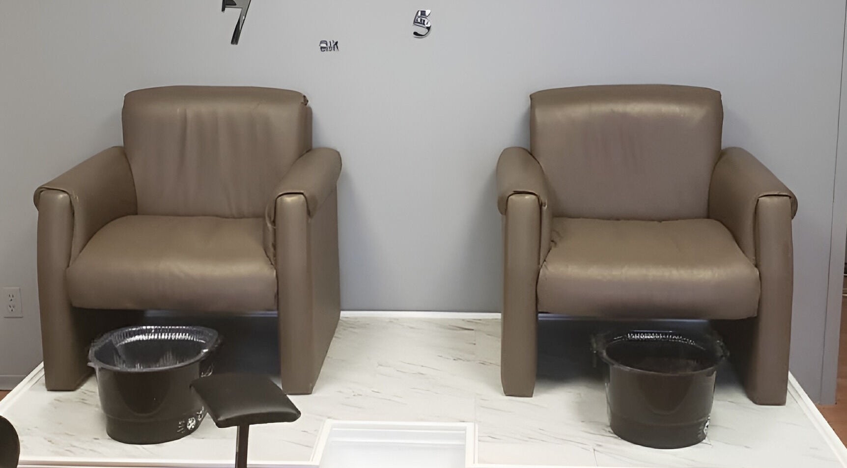 Relaxing pedicure chairs at Embellished Beauty - Dundalk 52 Main St E, Dundalk, Ontario, CA on marble flooring.